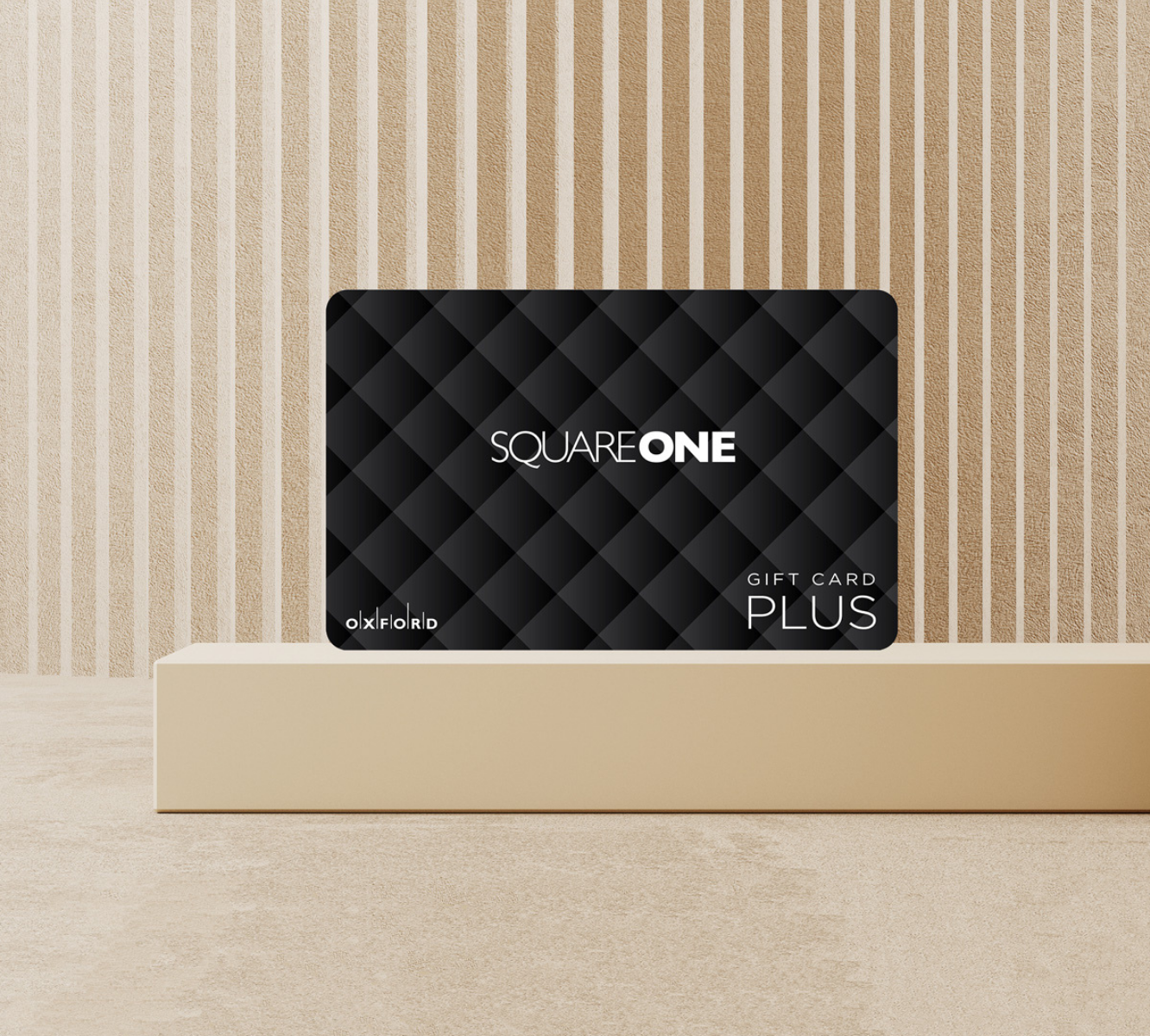Image of a Black Square One gift card perched on a beige podium with a beige background.