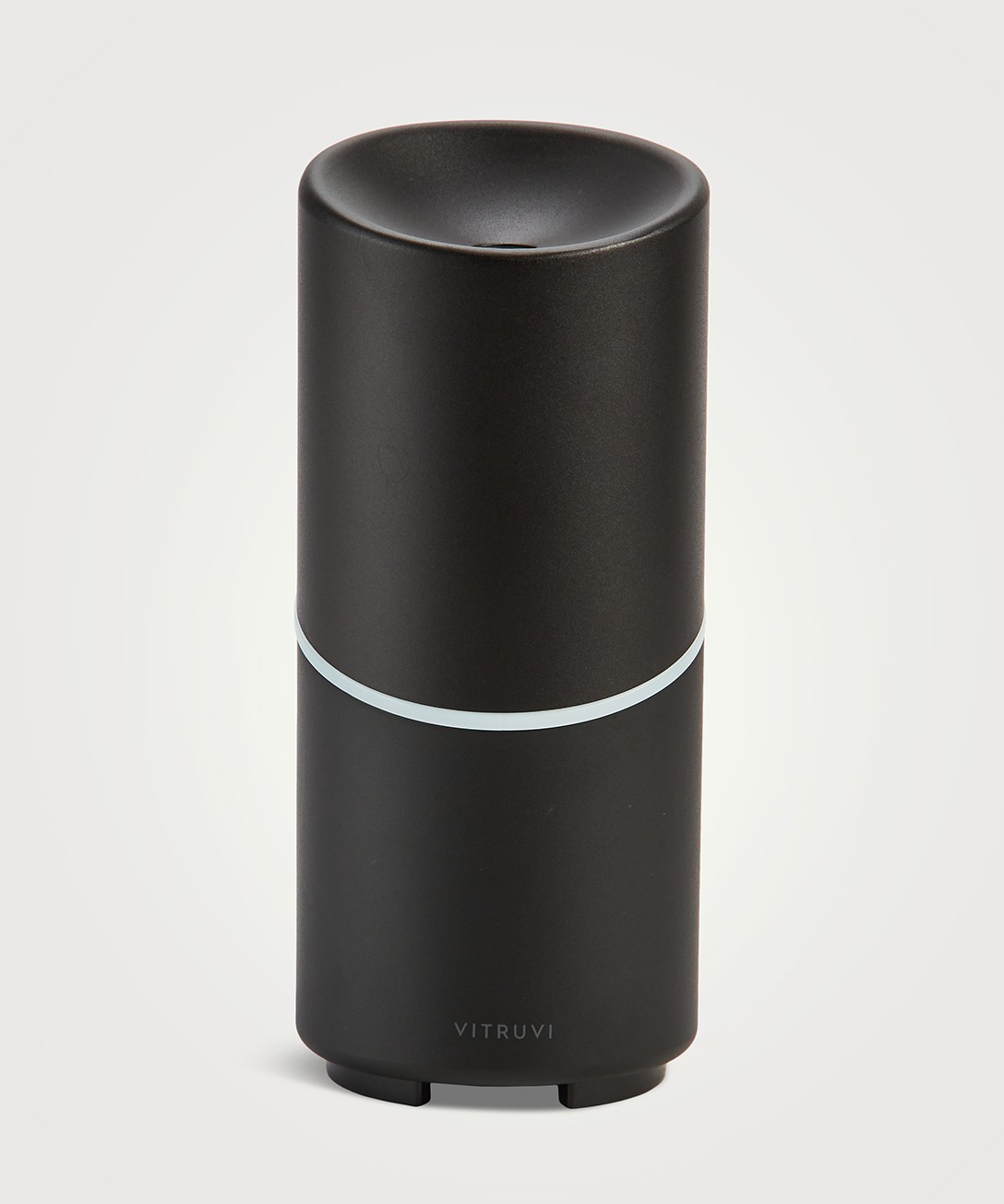 Image of a black Vitruvi diffuser in a cylinder shape.
