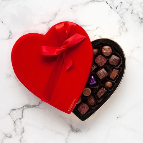 close-up of assorted truffles in a heart-shaped red box