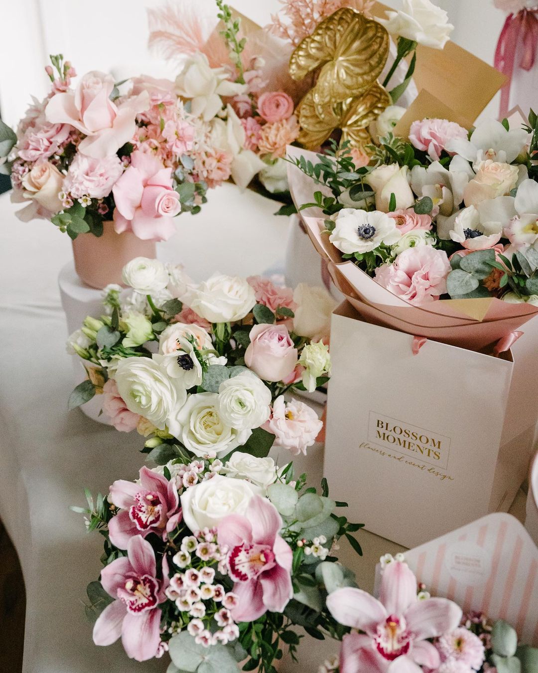 There are five floral arrangements ranging from medium to large is size. There are a variety of florals included. Colouring is pink, green, pink.
