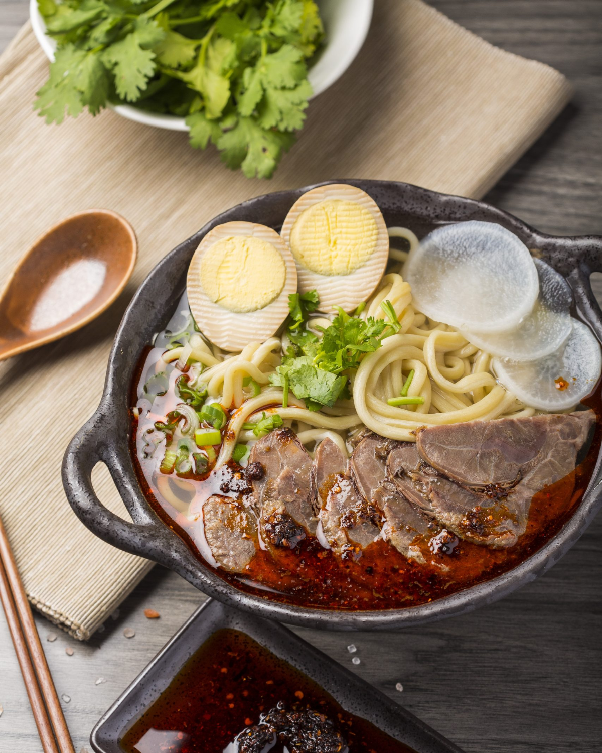 A bowl of beef slices, egg and noodles