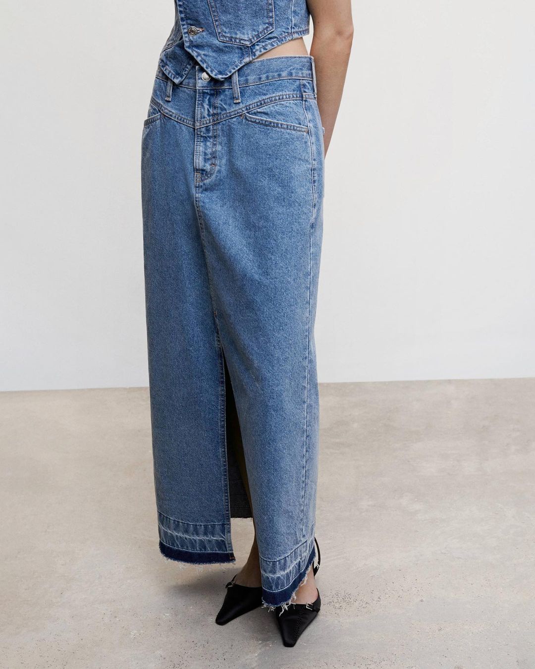 close-up image of a model wearing a denim maxi skirt from MANGO