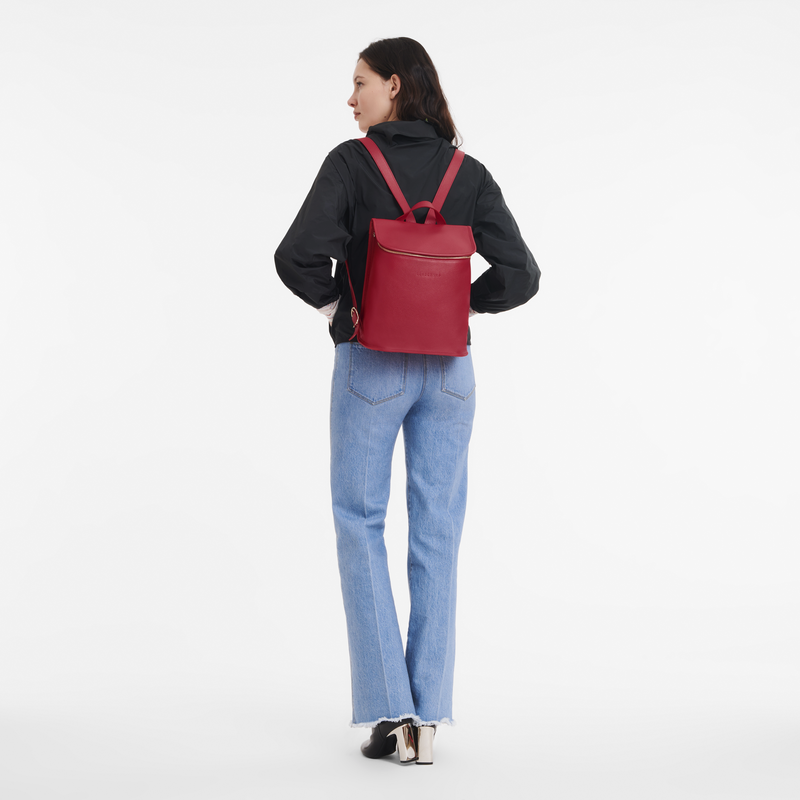 model wearing a red backpack