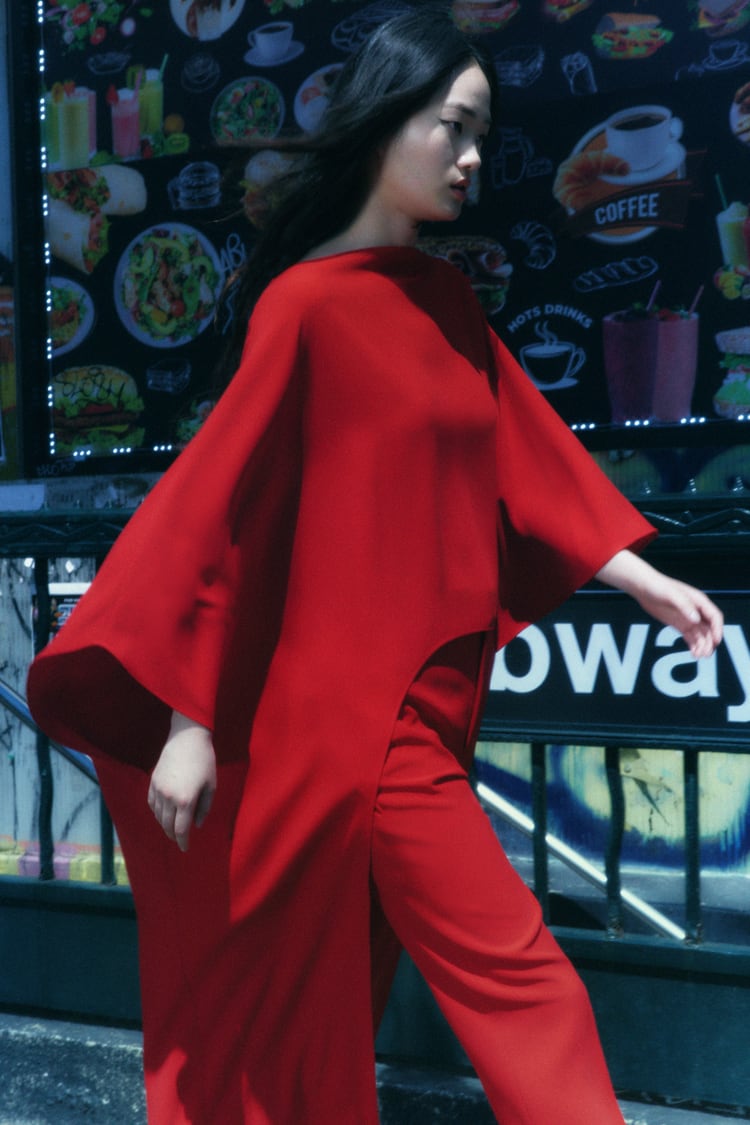 Model wearing a flowy, red dress from Zara