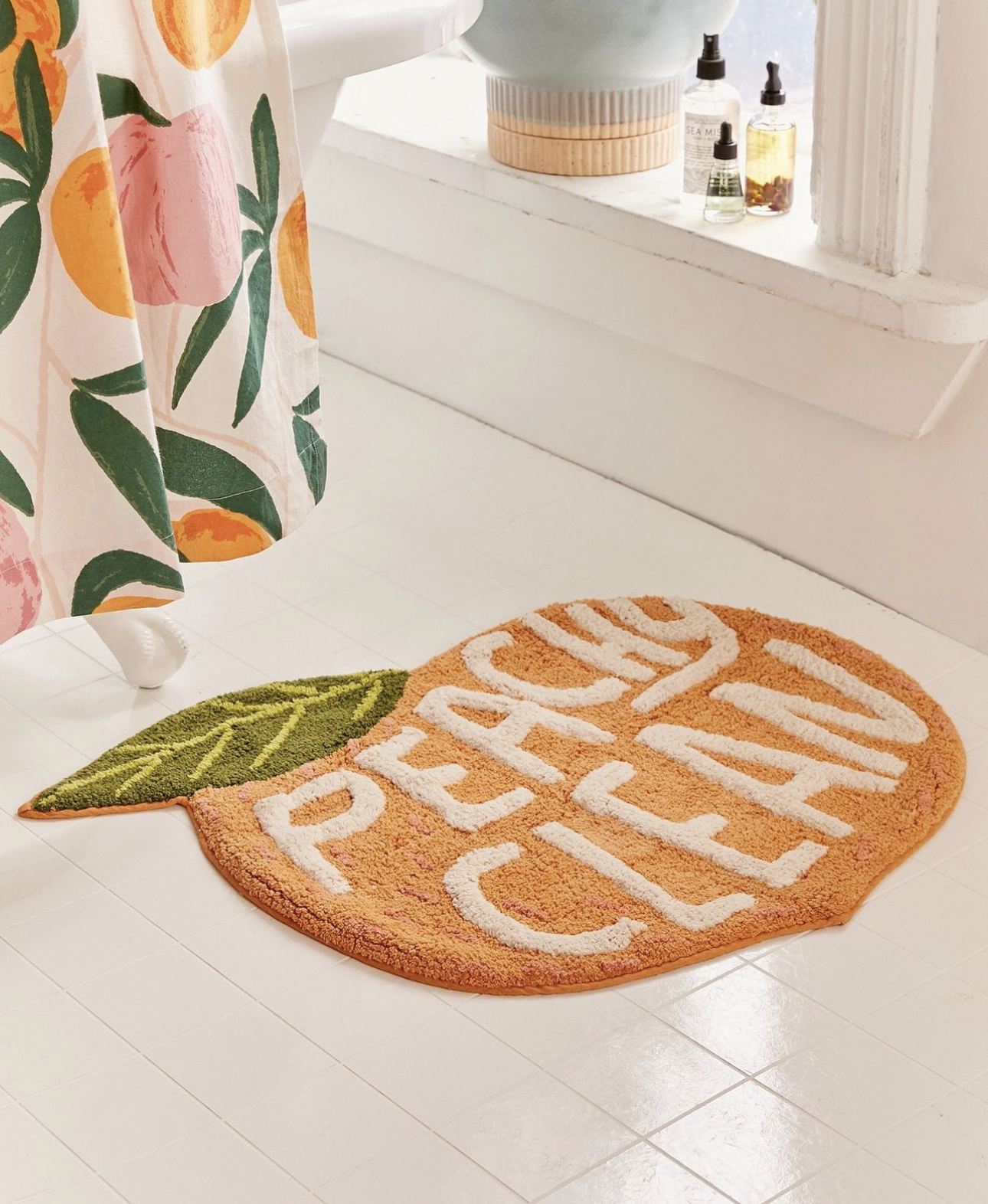 A bathroom rug in a peach design from Urban Outfitters