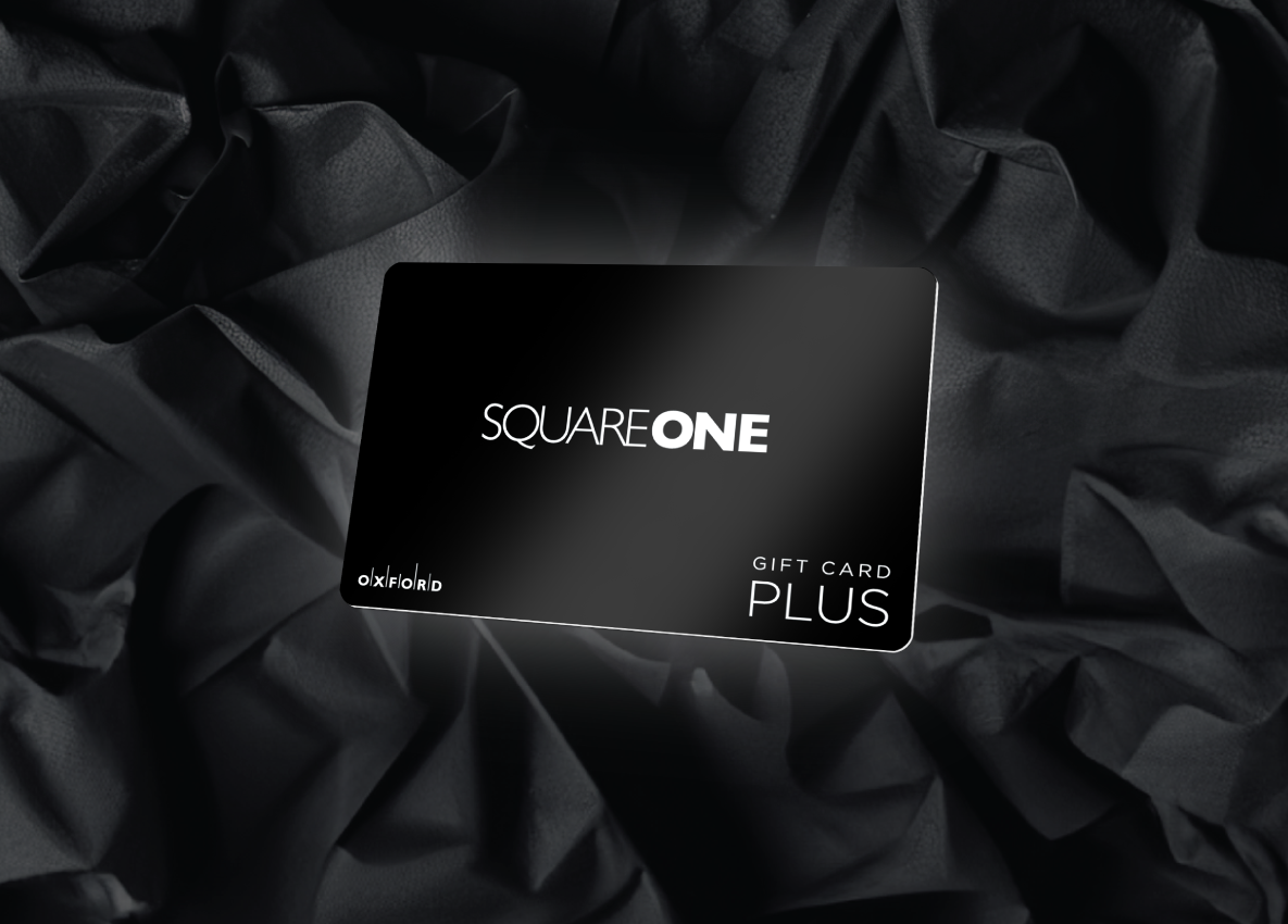 A black Square One gift card overlaying a background of black crinkled paper