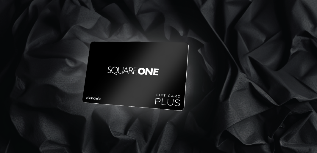 A black Square One gift card overlaying a background of black crinkled paper