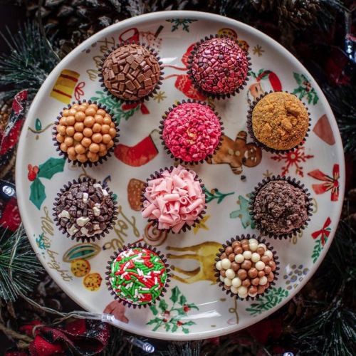 A platter of holiday themed chocolate Brigadeiros