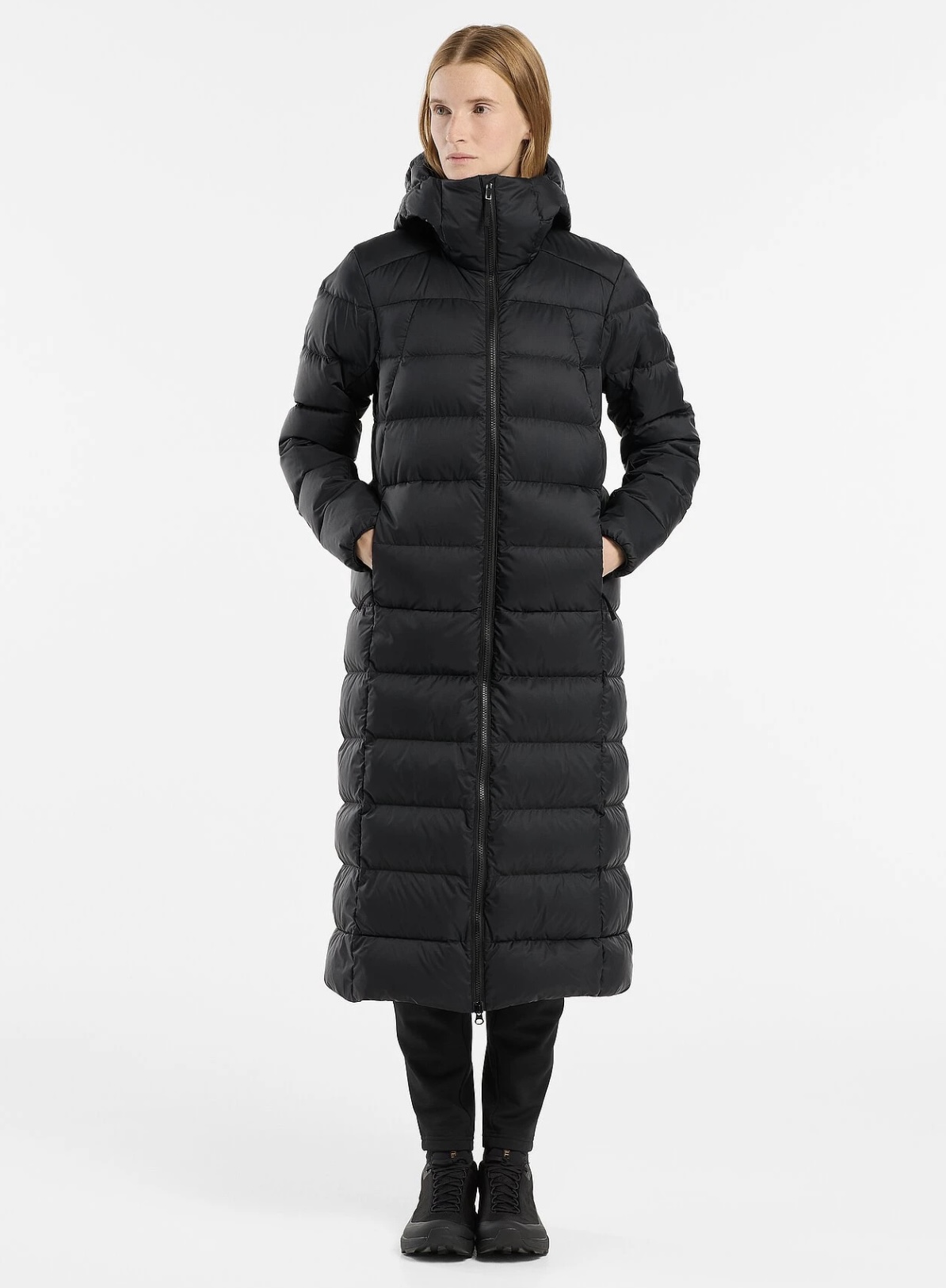 Woman wearing a long black puffer coat