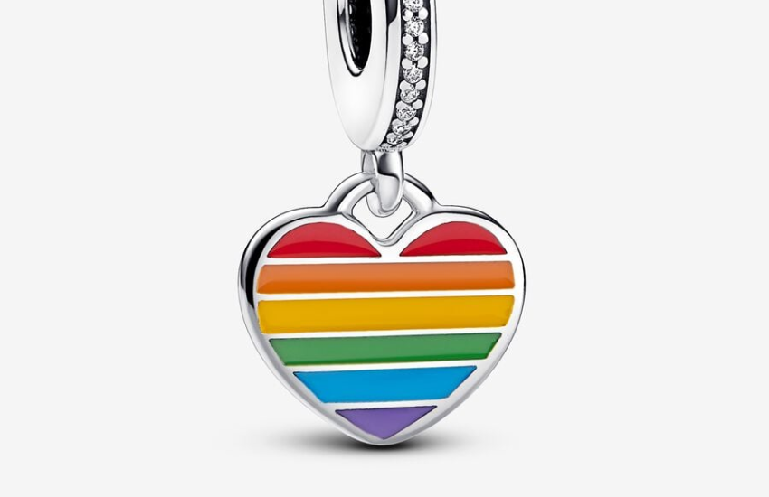 A heart shaped charm featuring a rainbow pattern