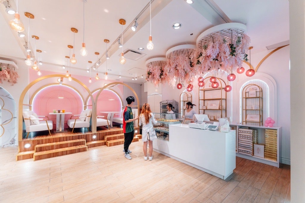 A photo of a pink coloured store selling donuts