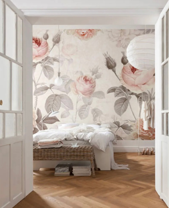 A bedroom with a floral wallpaper