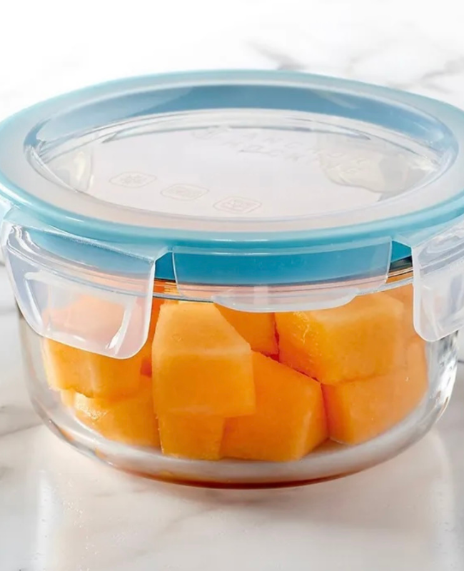 A Tupperware container holding sliced fruit