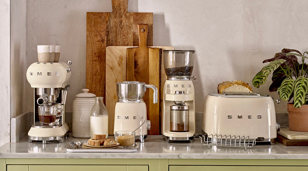 Kitchen counter with various white SMEG appliances