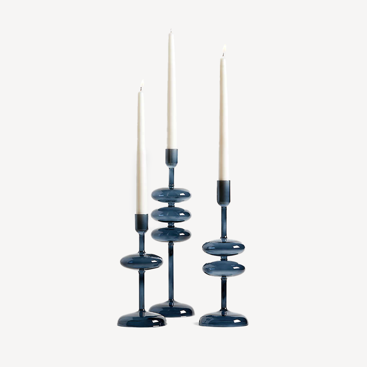 Three blue candle holders with candles