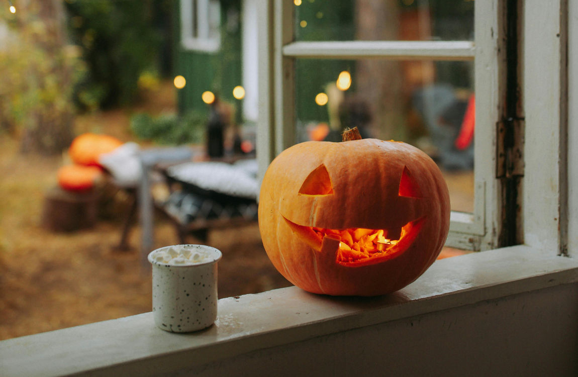 A Jack-O-Lantern on a window sill.