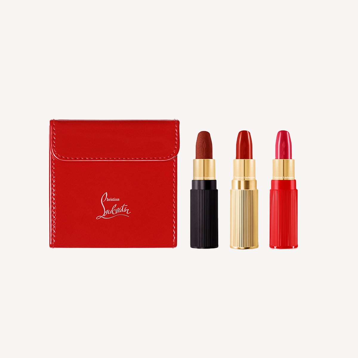 Three red lipsticks beside a red box