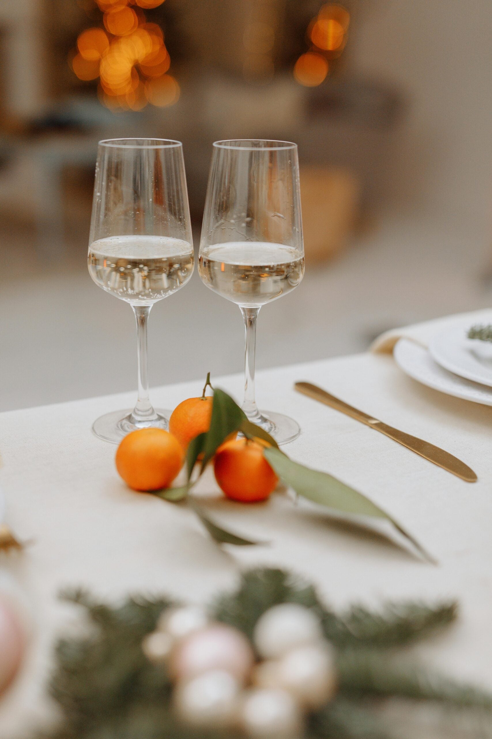 Two wine glasses on a table scape.