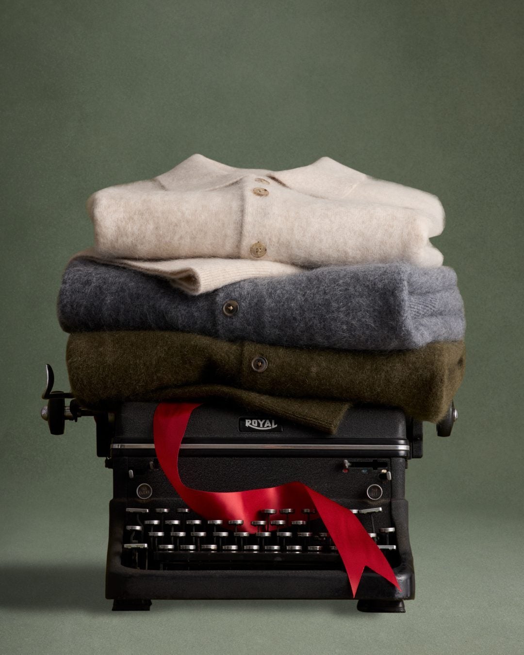 A pile of knit sweaters on a typewriter