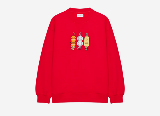 A red crewneck sweater with a paper latern motif design on the chest.