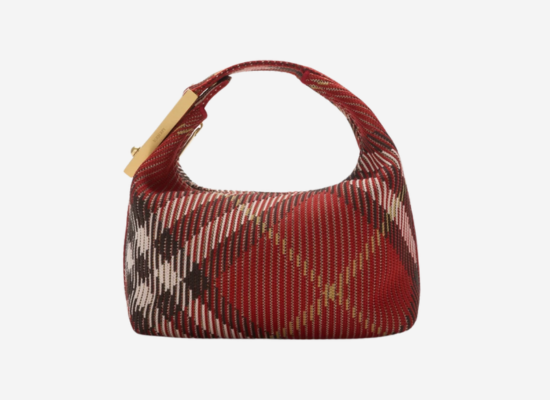 A red handbag with the signature Burberry checked pattern.