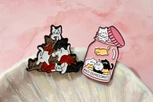 Small pins featuring cat designs.