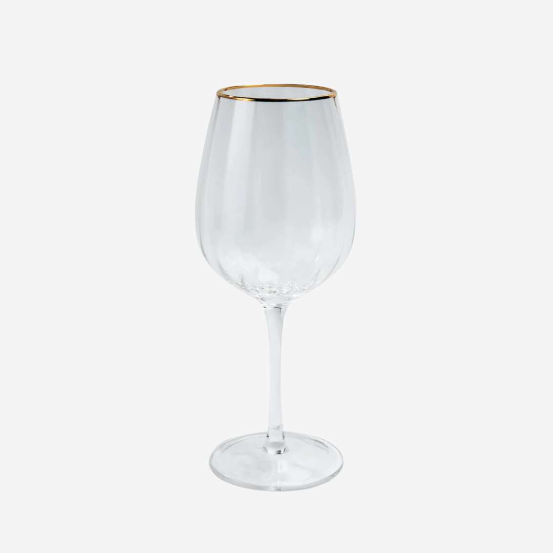 A wine glass with gold accent on the rim.