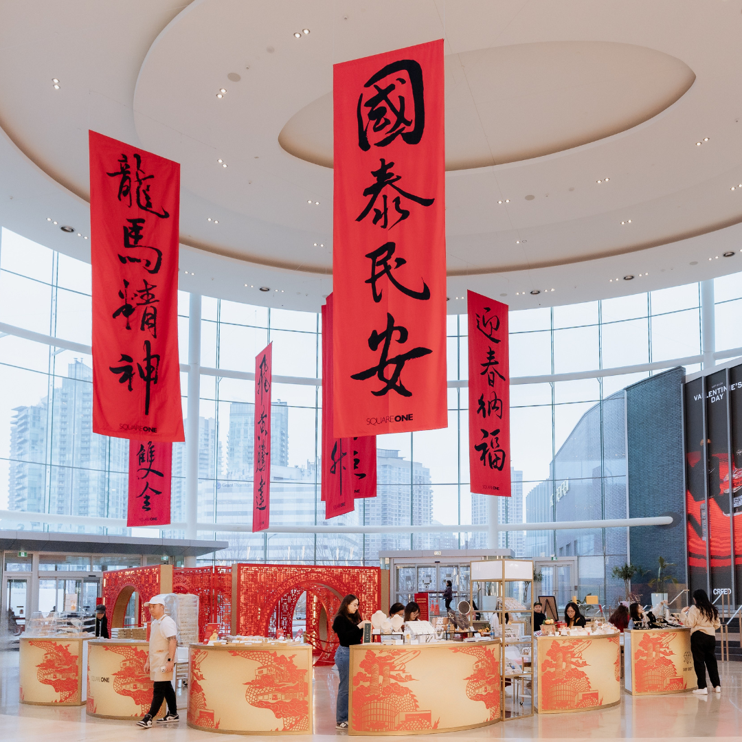 Red and gold vendor booths with red scrolls hanging from above.