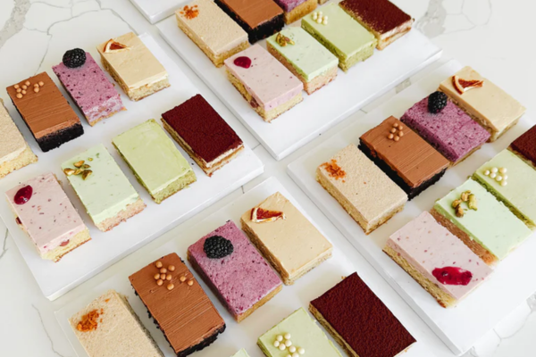 An assortment of small layered cakes.