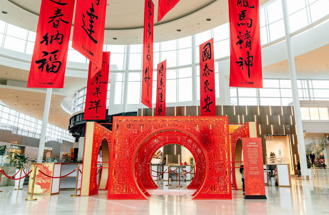 A red arch with red hanging scrolls above it.