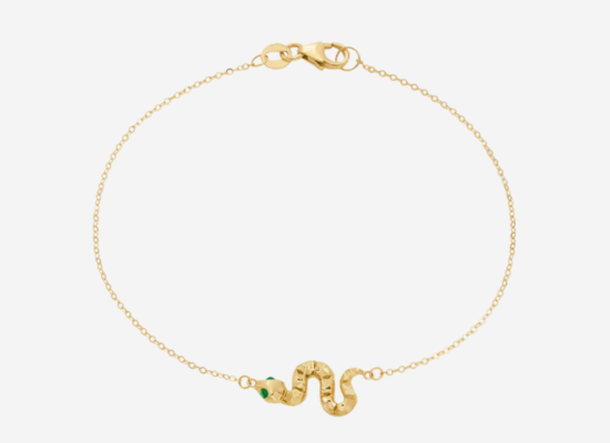 A gold bracelet with a snake pendant.