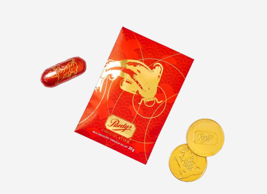 A red envelope surrounded by wrapped chocolates.