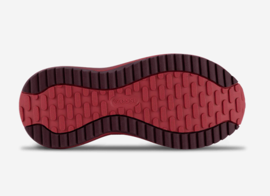 The red outsole of a red shoe.