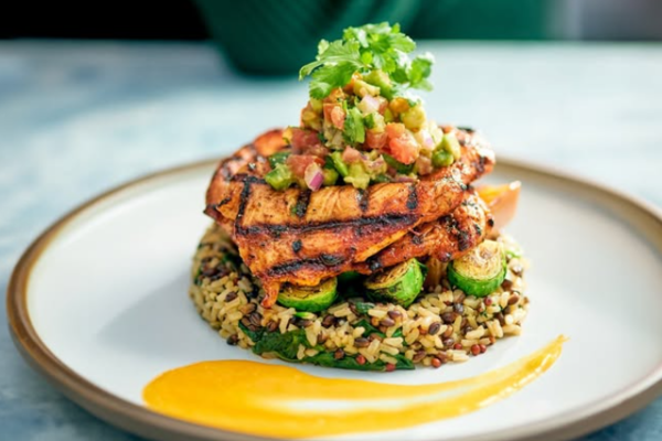 A plate of grilled chicken and rice.