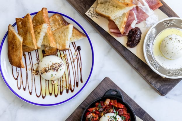 Plates of bread, cheese and sliced meat.