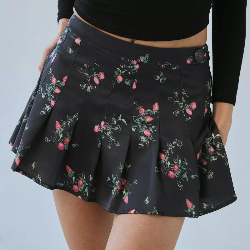 A woman wearing a floral print black skirt.