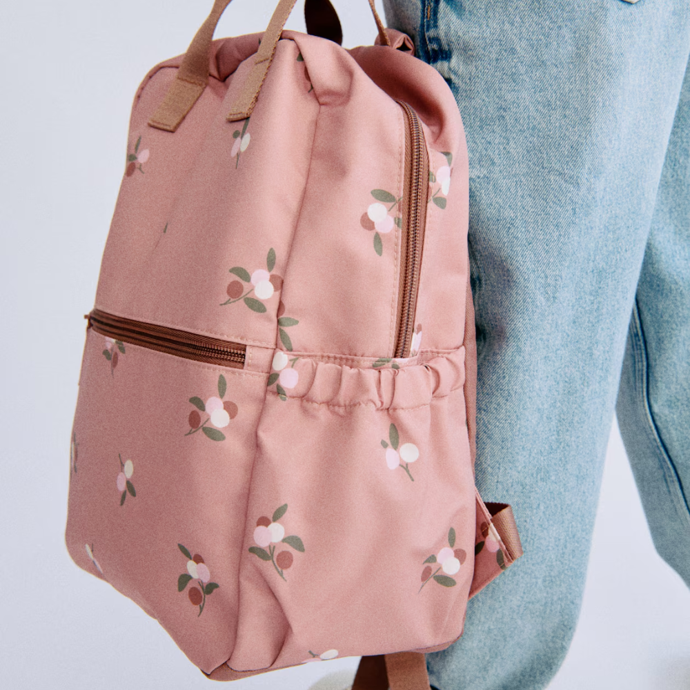A pink backpack from H&M with a floral motif