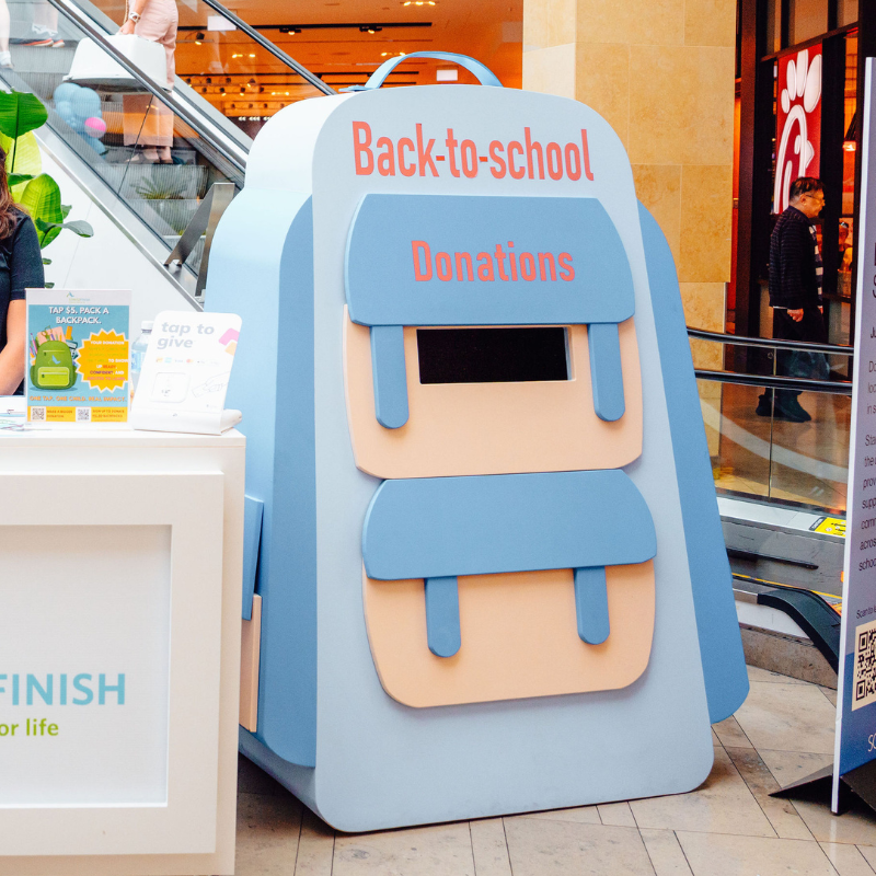 A backpack-shaped school supply donation bin.