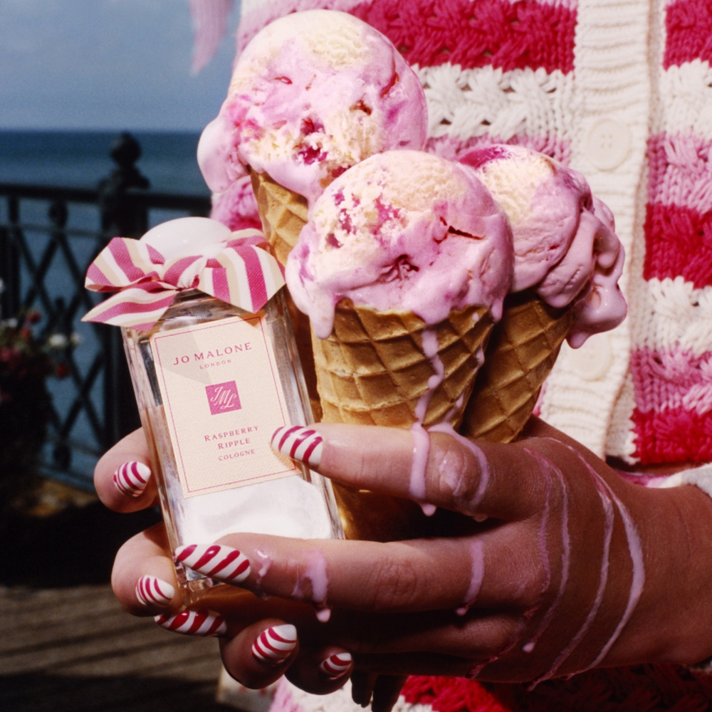 Someone holding melting raspberry ice cream and the new Raspberry Ripple scent from Jo Malone