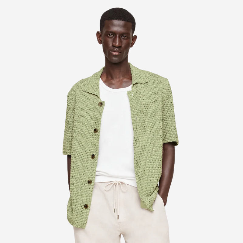 A man wearing a bright green knit polo