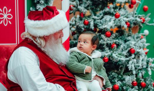 Santa taking a photo with a baby.