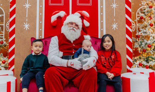 Santa taking a photo with children.