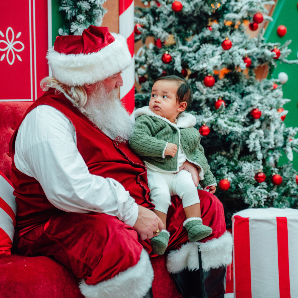 Santa with a baby on his lap.