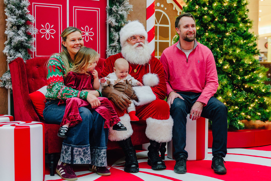 Santa posing for a photo with a family
