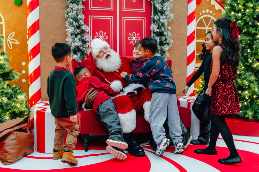 Santa surrounded by young children