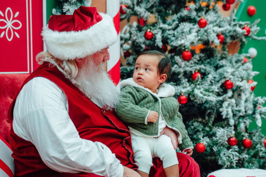 Santa looking at a young baby
