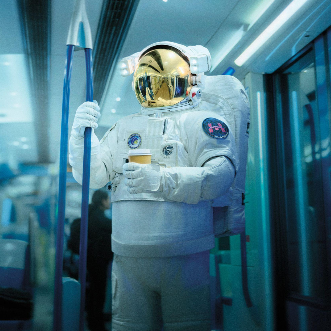 An astronaut on a subway car
