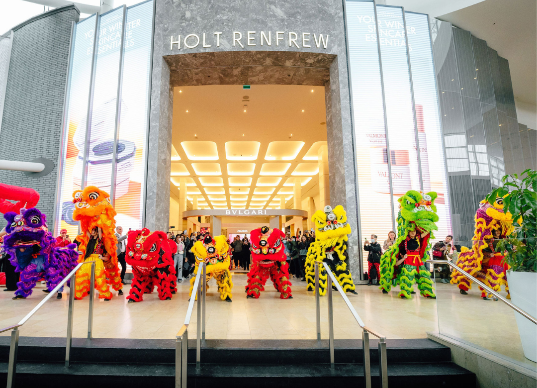 A lion and dragon dance performance in front of Holt Renfrew.