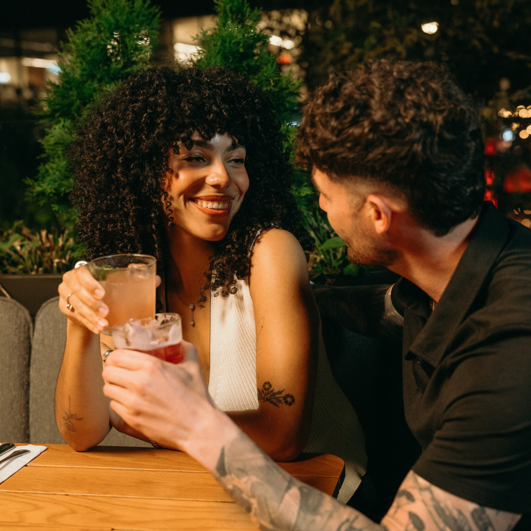 A woman and man having a drink at a restaurant together